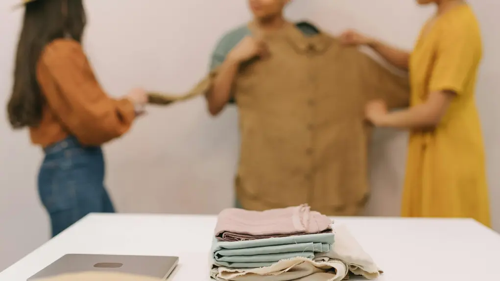 3 women looking at a shirt