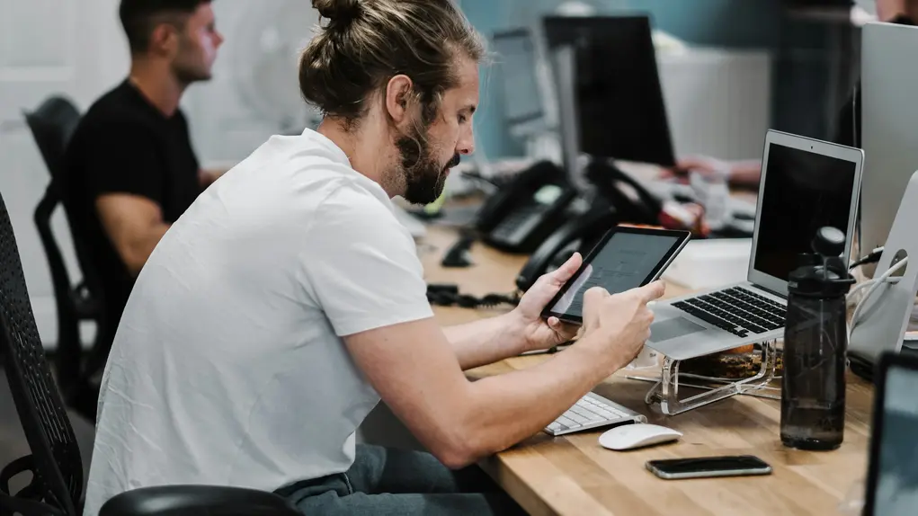 Man sat by a desk with poor posture